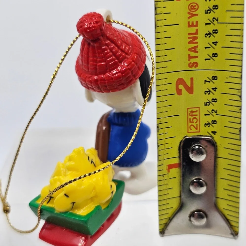 Snoopy Pulling Woodstocks Christmas Ornament. Peanuts. United Feature Syndicate
